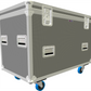 Large metallic flight case with wheels on a white background