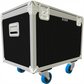 Black flight case with silver corners and blue wheels on a white background