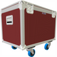 Red flight case with white frame and blue wheels on a white background
