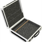 Open hard-shell carrying case with black interior padding on a white background